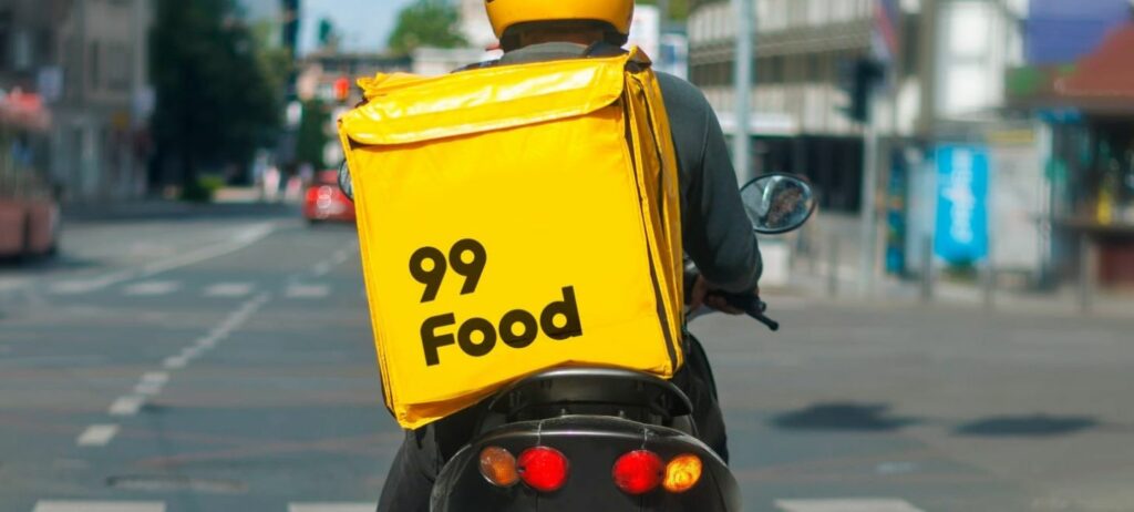 Motoqueiro usa bag amarela com a inscrição 99Food